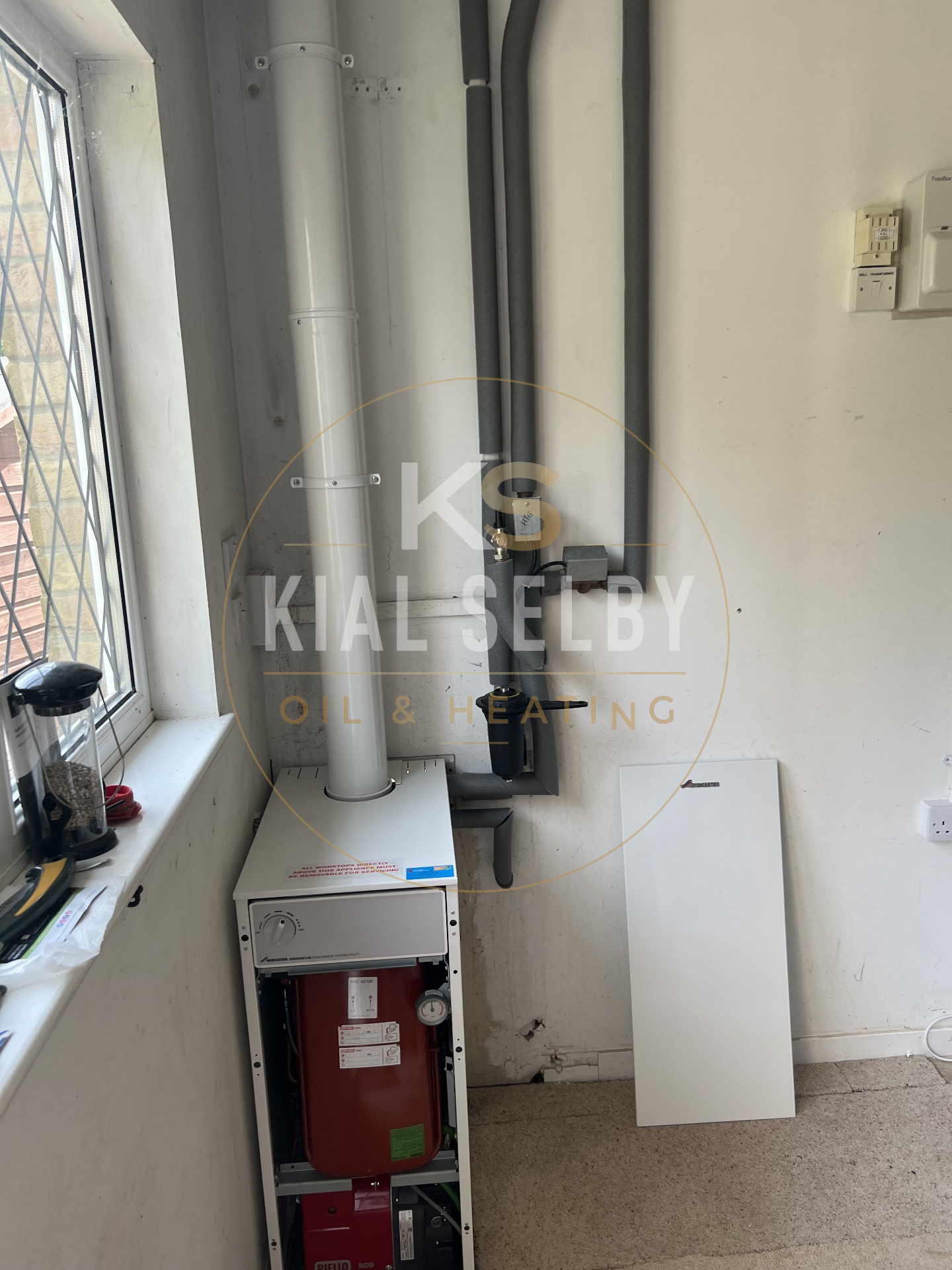 Internal oil boiler with insulated pipework and flue